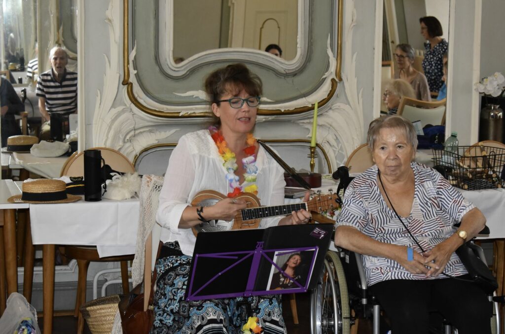 Im großen Spiegelsaal der Seniorenbetreuung Schloss Schliestedt startet Annie We mit den Bewohnerinnen und Bewohnern mit einem Konzert zum Mitmachen in den Tag – bevor es in die individuelle musikalische Biografiearbeit geht.